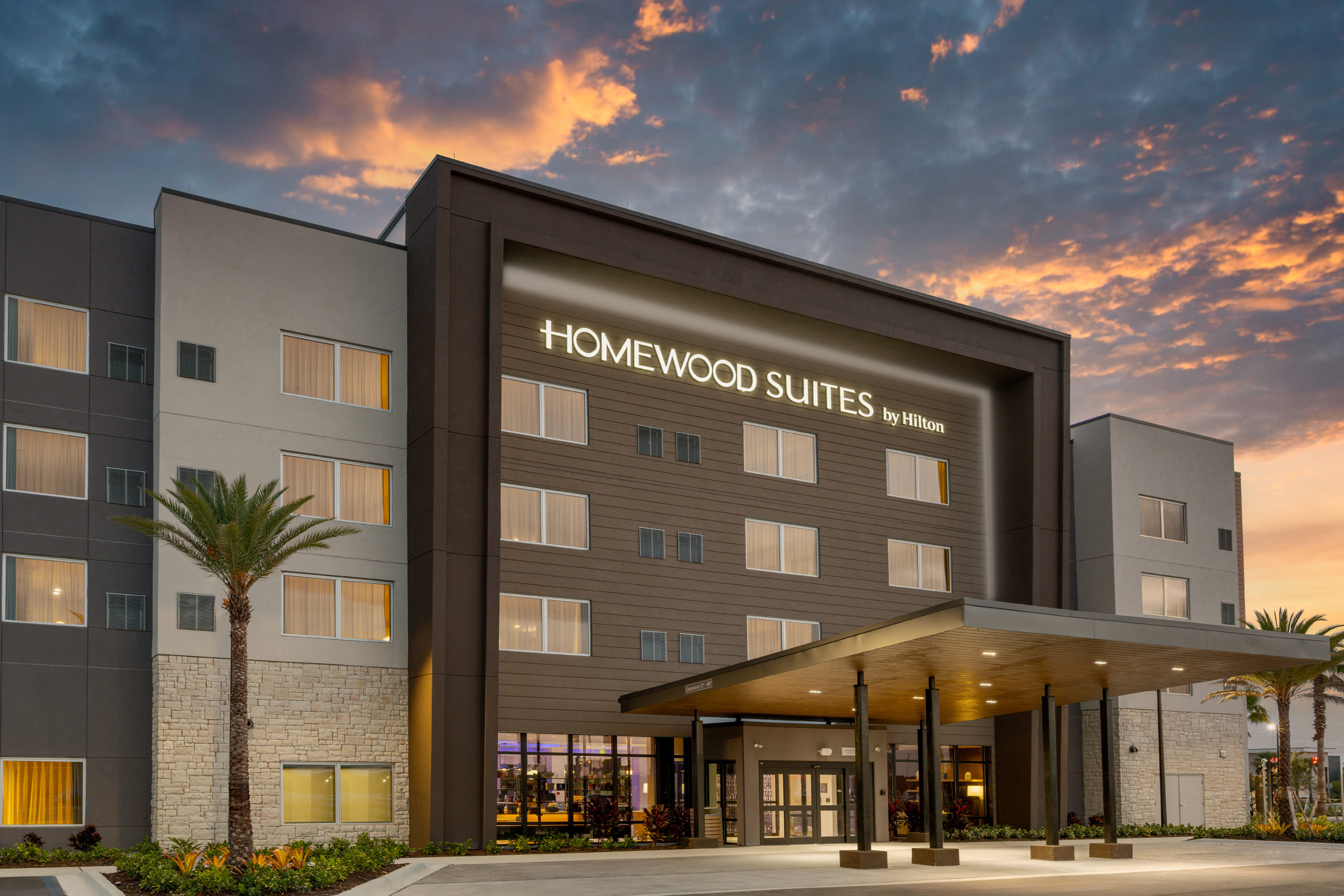 New construction hotel exterior architecture photography for Central Oregon builders featuring contemporary Homewood Suites design with mixed materials, modern hospitality architecture for Bend Oregon architects